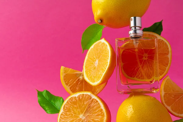 Beautiful composition with bottle of perfume and citrus fruits — Stock Photo, Image