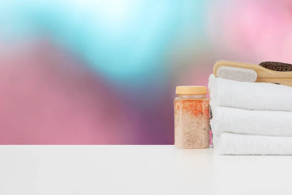 Various spa beauty threatment products and towels against blurred background — Stock Photo, Image