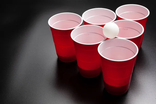 Beer pong college game on black background — Stock Photo, Image