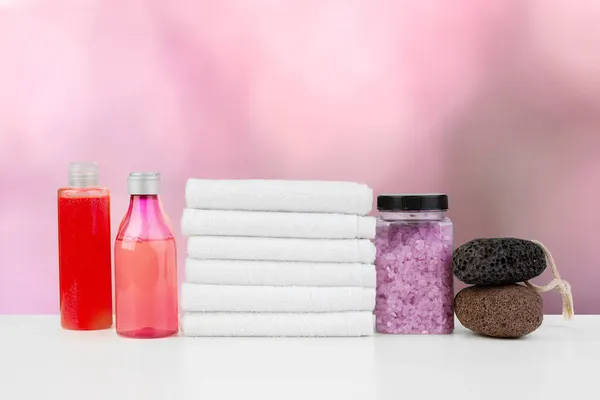 Various spa beauty threatment products and towels against blurred background — Stock Photo, Image