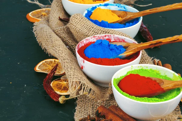 Traditional Indian Holi colours powder, spices on dark rustic background — Stock Photo, Image