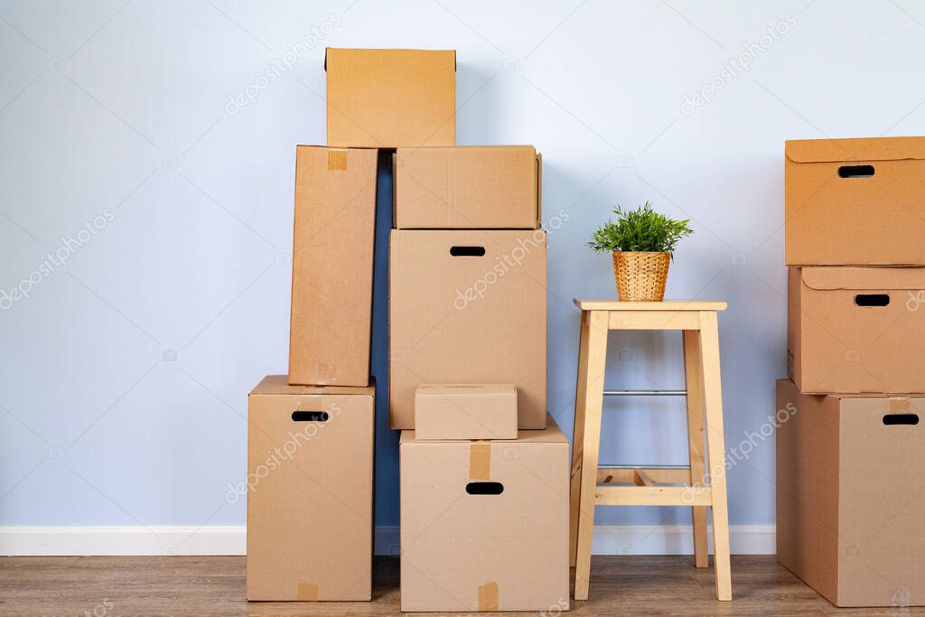 Moving boxes with packed stuff and chair for moving