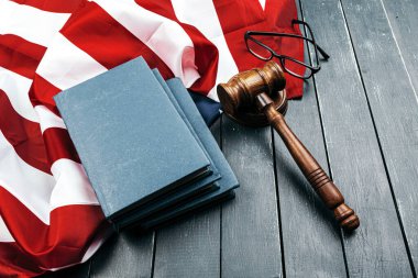 Yargıç Tokmak, Amerika Birleşik Devletleri bayrağının arka planında