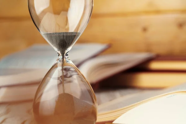 Sandglass clock close up on a table Stock Picture