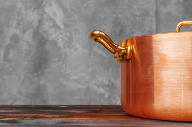 Ahşap masada bakır tencere yığını. Yakın çekim.