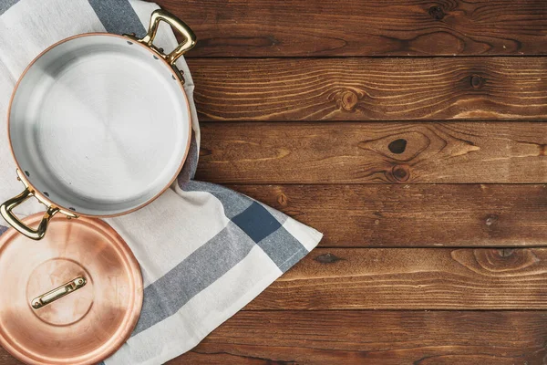 Ahşap tahtada temiz bakır mutfak malzemeleri.