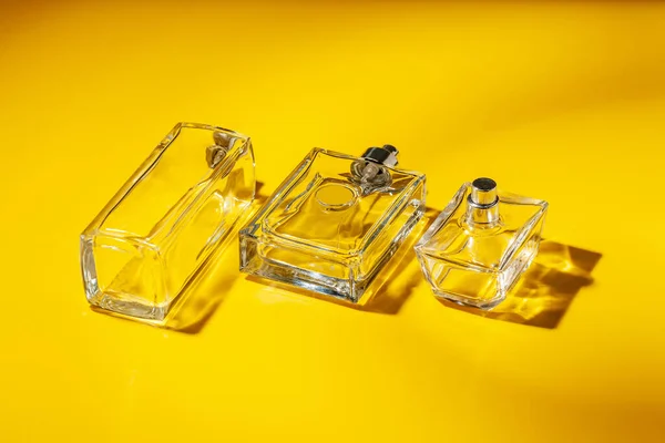 Perfume glass bottle on light yellow background. Eau de toilette — Stock Photo, Image