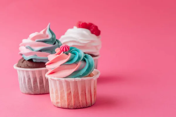 stock image Tasty cupcakes sweets on pink background close up