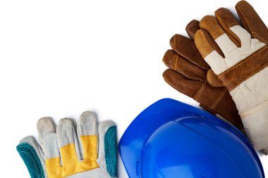 Güvenlik şapkası ve iş eldivenleri beyaz arka planda izole edilmiş.