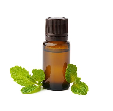 Beyaz arka planda, gerekli yağ ve yeşil yapraklı bir şişe.