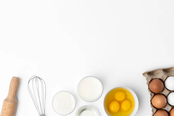 Batedor de metal e ovos para cozinhar isolados em branco — Fotografia de Stock