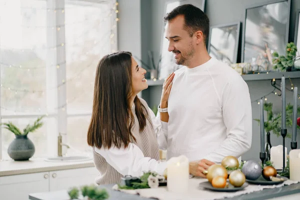 Young loving couple having good time at Christmas morning in kitchen — Stock Photo, Image