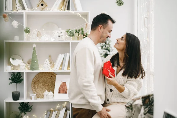 Jovem casal alegre no amor com presente para o Natal — Fotografia de Stock