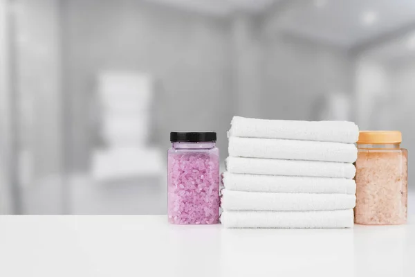 Various spa beauty threatment products and towels against blurred background — Stock Photo, Image