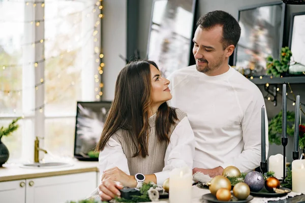 Jovem casal amoroso se divertindo na manhã de Natal na cozinha — Fotografia de Stock