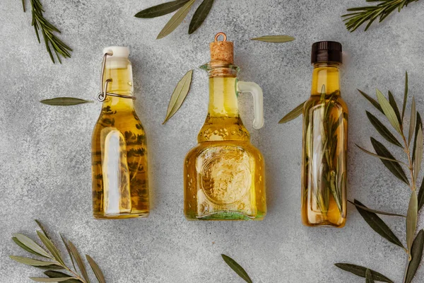 Скляна пляшка з оливковою олією на сірому фоні — стокове фото