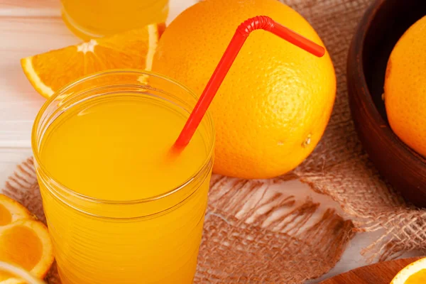 Close up of orange juice glass on wooden table — Stock Photo, Image
