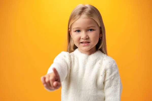 Little girl presses an imaginary button with her finger — Stock Fotó