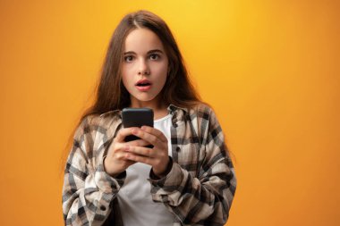 Portrait of a smiling young girl using smartphone