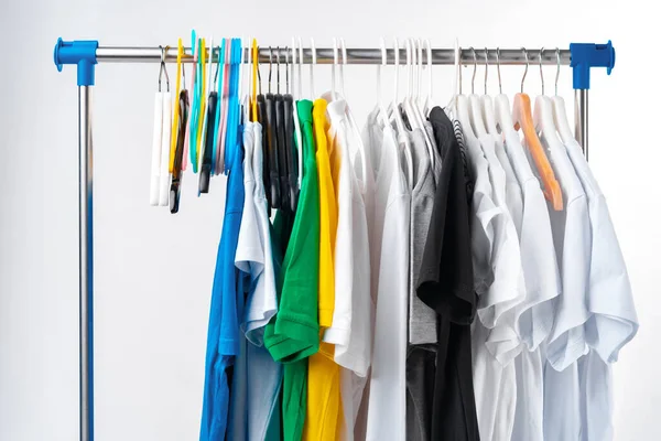 Clothes hang on clothing rack over white background. — Stock Photo, Image