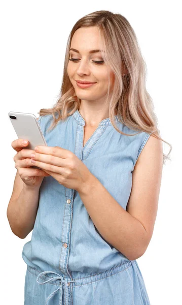 Portrait of a smiling casual woman holding smartphone over white background — Stock Photo, Image