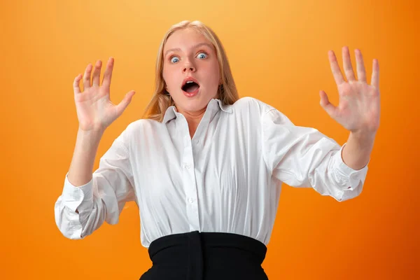 Photo of worried nervous teen girl afraid of something against orange background — Stock Photo, Image