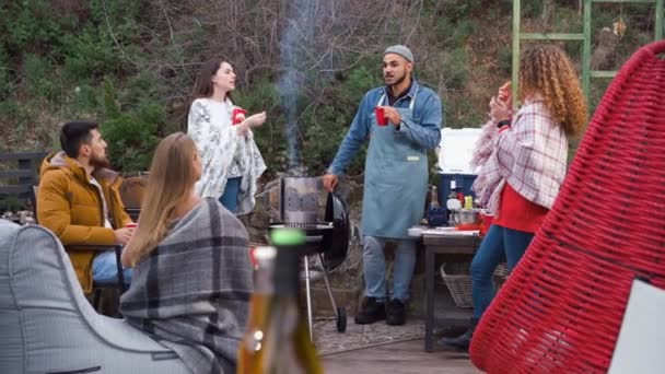 Amigos haciendo una fiesta de barbacoa en el patio trasero en otoño — Vídeos de Stock