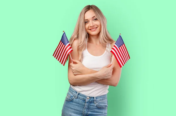 Retrato de uma jovem segurando bandeira dos EUA isolada no fundo da cor — Fotografia de Stock