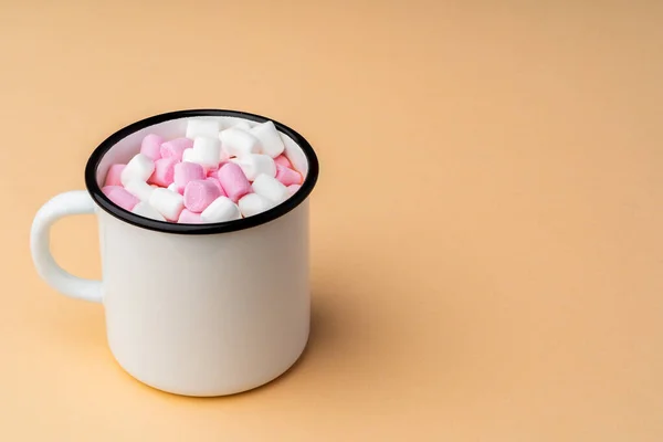 Cup of cocoa with marshmallows on beige background — Stock Photo, Image
