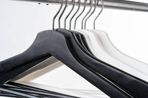 Metal rack with clothes hangers on white background — Stock Photo, Image