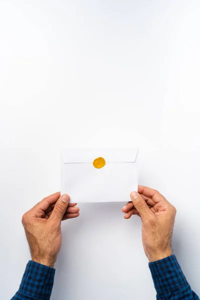 Manliga händer håller ett kuvert med en vax tätning — Stockfoto