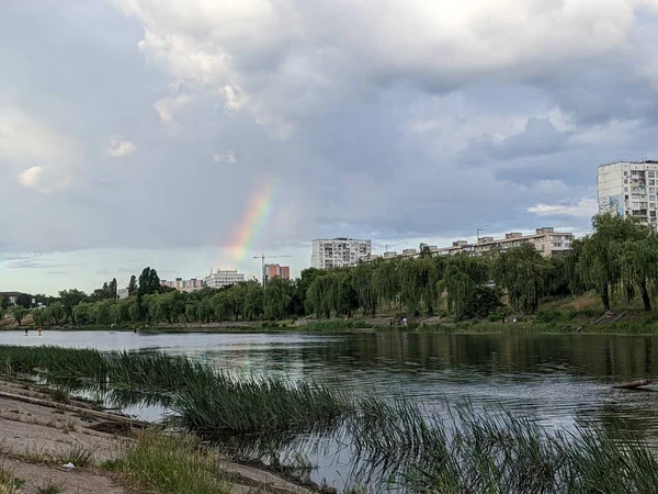 beautiful landscape with rainbow, river and houses in Kyiv