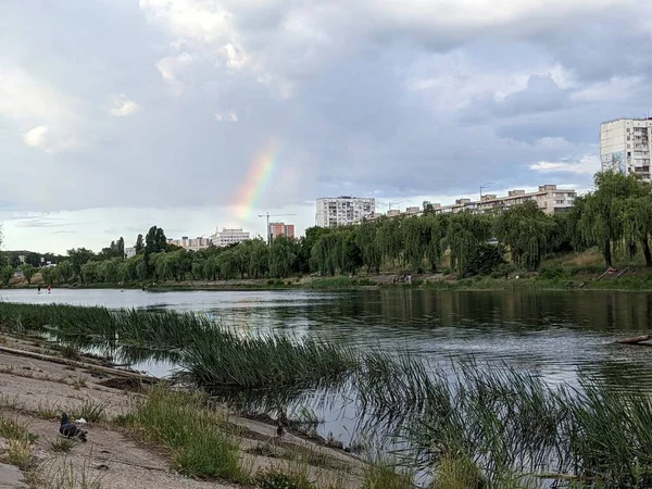 beautiful landscape with rainbow, river and houses in Kyiv