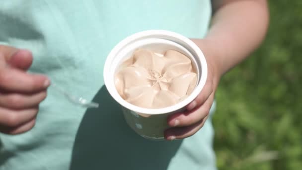 Παιδί Παίρνει Ένα Πλαστικό Κουτάλι Παγωτό Από Ένα Φλιτζάνι — Αρχείο Βίντεο