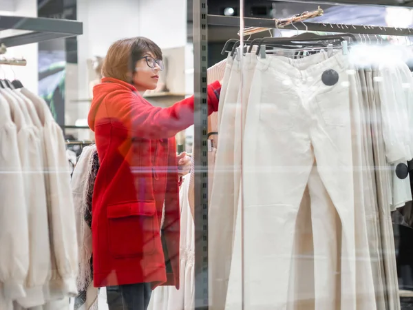 Woman Chooses Trousers Clothing Store Casual Trousers Hanging Hangers View — Fotografia de Stock