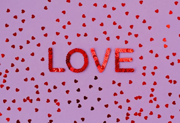 Inscription Love Embroidered Red Sequins Purple Background Scattered Random Sequins — Stock Photo, Image