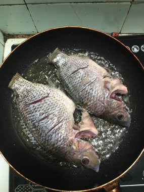 Fried whole Tilapia Fish in a Frying Pan