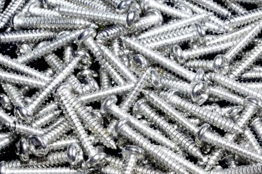 Krom kaplamalı vidaların izole edilmiş görüntüsü beyaz arkaplanda yakın plan.