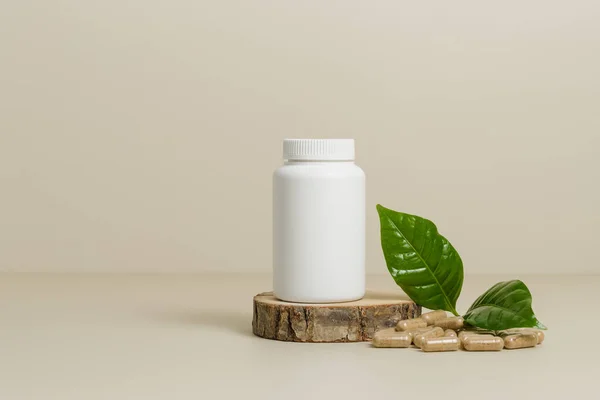 Mockup bottle with herbal pills or vitamins with green leaf, bio supplement, organic vitamins with copy space, beige background