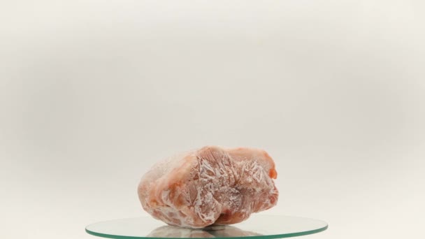 Pieces Frozen Rotating Meat White Background Which Blows Frosty Freshness — Vídeo de stock