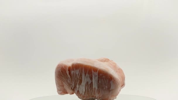 Pieces Frozen Rotating Meat White Background Which Blows Frosty Freshness — Vídeo de Stock