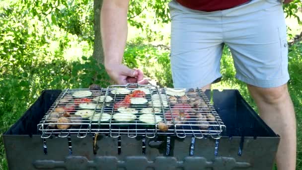 Man Turns Roasted Assorted Vegetables Barbecue Tomatoes Zucchini Mushroom Mushrooms — Stockvideo