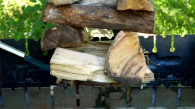 Man ignites fire wood in grill with a gas torch. Head of the family is going to cook barbecue