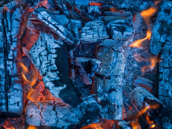 Close up shot of charcoal burning out flames in a bbq grill