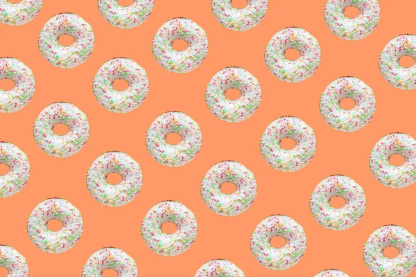Шаблон Кольцевых Пончиков Белой Глазурью Пышные Сотни Тысячи Оранжевом Фоне — стоковое фото