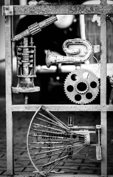 Metal scrap installation made of old cars and motorcycles parts