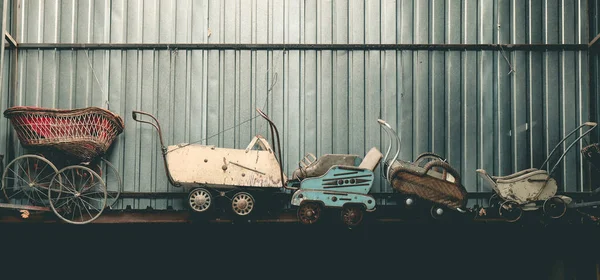 Collection of very old worn out strollers
