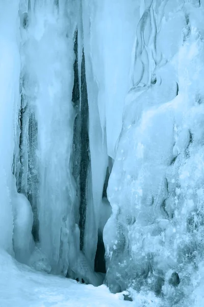 A frozen waterfall with ice in winter. Winter background.