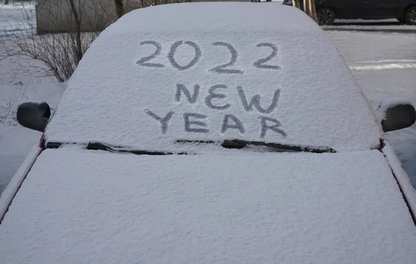 2022年あけましておめでとうございます フロントガラスのワイパーと雪に覆われた車 冬の季節 正面図 — ストック写真