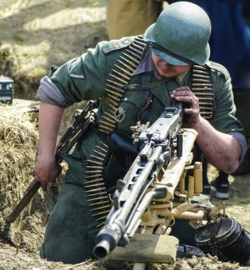 İkinci Dünya Savaşı sırasında askerlerin tarihi yeniden canlandırması. Yüzü yok. Alman askerleri. Yeniden yapılanma, 2. Dünya Savaşı sırasında savaşan askerler. makineli tüfekçi